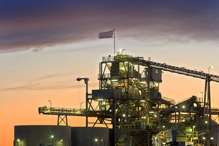 A gravel plant with beautiful sunset colors as background.