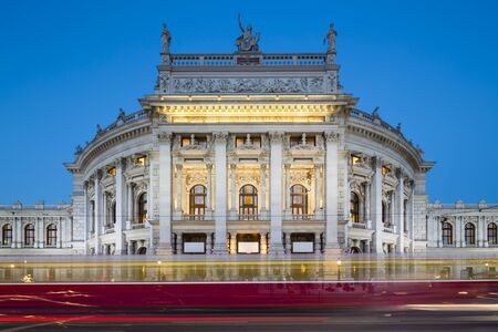 View of the Burgtheater in Vienna, Austria at night with a tram passingの写真素材