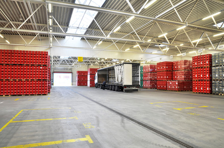 loading of goods in a brewery warehouse - beer crates with beer bottlesの写真素材