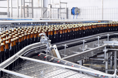 conveyor belt of a brewery - beer bottles in production and bottlingの写真素材