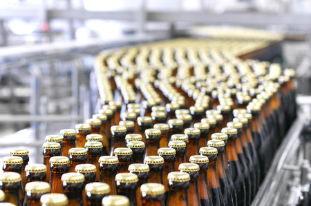 beer filling in a brewery - conveyor belt with glass bottlesの写真素材