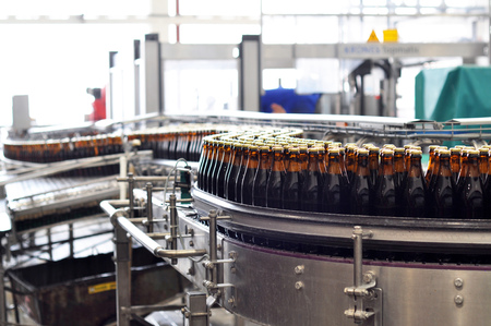 beer filling in a brewery - conveyor belt with glass bottlesの写真素材