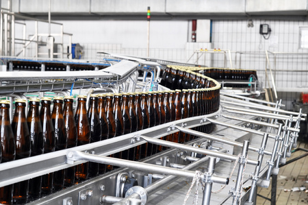 beer filling in a brewery - conveyor belt with glass bottlesの写真素材
