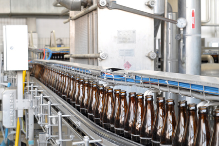 beer filling in a brewery - conveyor belt with glass bottlesの写真素材