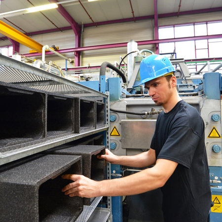 worker operating machine in the plastics industry - production of styrofoam componentsの写真素材