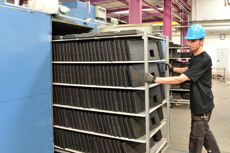 Worker operating machine in the plastics industry - production of styrofoam componentsの写真素材