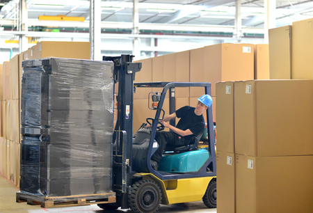 forklift driver in a warehouse for industrial goodsの写真素材