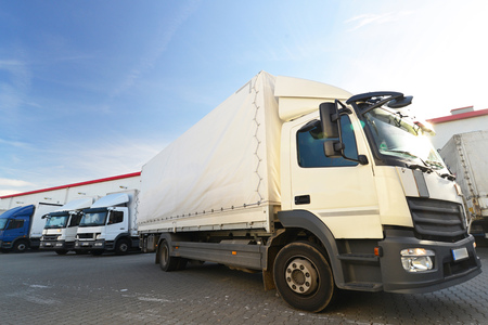 trucks are loaded with goods at the depot in a shipping companyの写真素材