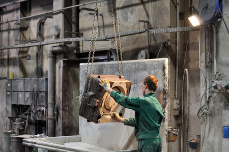 Workers in a foundry - production of steel casting in an industrial companyの写真素材