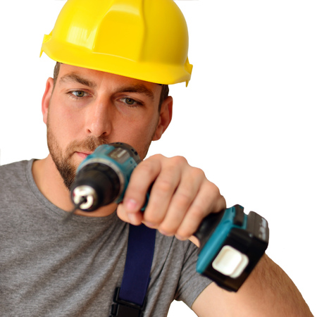 freestanding craftsman construction worker assembler with drilling machine - friendly worker in clothes on white backgroundの写真素材