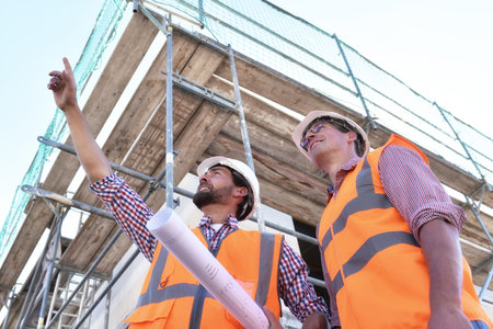 teamwork on the construction site - site manager and architect on site during the construction of a...