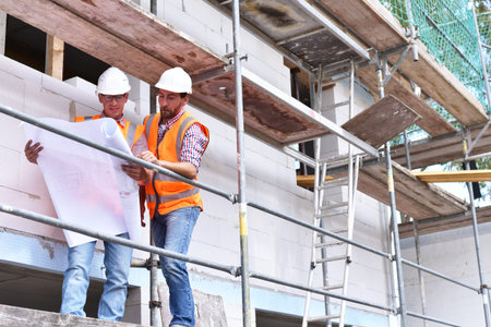 Teamwork on the construction site - site manager and architect on site during the construction of a...