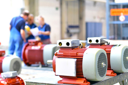 Workers in a factory assemble electric motorsの写真素材