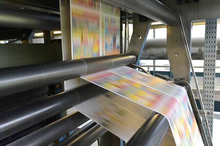 printing of coloured newspapers with an offset printing machine at a printing press companyの写真素材