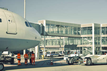 handling of an aircraft at the airport - ground staff and buildingsのeditorial素材