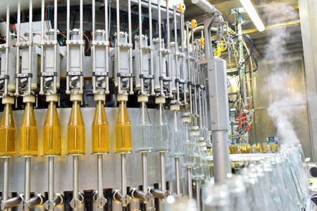 apple juice in glass bottles in a factory for the food industry - bottling and transport 