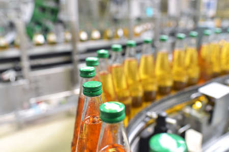 apple juice in glass bottles in a factory for the food industry - bottling and transportの写真素材