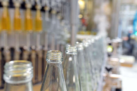 apple juice in glass bottles in a factory for the food industry - bottling and transportの写真素材