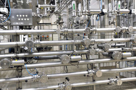 Industrial plant in a modern brewery - technology in a factory building with pipes and fittingsの写真素材