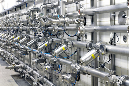 Industrial plant in a modern brewery - technology in a factory building with pipes and fittings