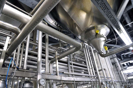 Industrial plant in a modern brewery - technology in a factory building with pipes and fittingsの写真素材