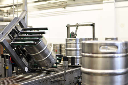 beer barrels in the filling process in a brewery - beer production in the modern food industryの写真素材