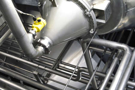 Industrial plant in a modern brewery - technology in a factory building with pipes and fittingsの写真素材