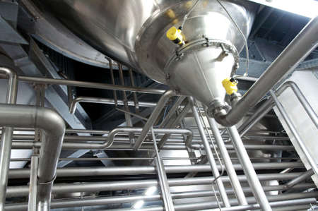 Industrial plant in a modern brewery - technology in a factory building with pipes and fittingsの写真素材