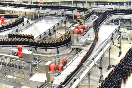 Modern factory in the food industry - beer brewery - conveyor belt with beer bottles and machines...