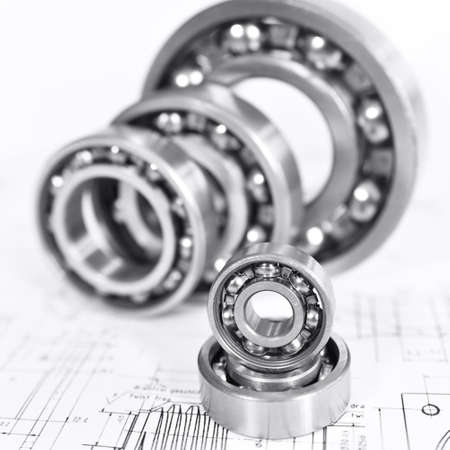 Quality control in modern mechanical engineering - technical drawing and ball bearings on white backgroundの写真素材