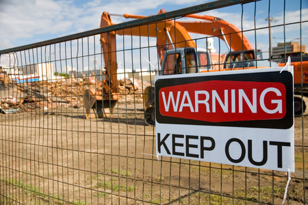Demolished building, with a keep put sign on the fence.