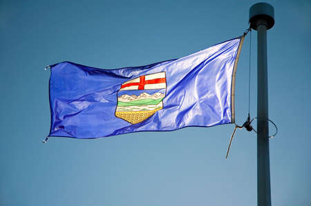 Alberta's provincial flag flying from a flag pole.の写真素材