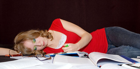 Overwhelmed student fell asleep studying.