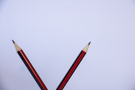 Two pencils isolated on white background with large copy space. Minimal education and study concept for school, learning, writing and academic workspace.の写真素材