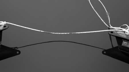 2 canoes tied together on a calm pond in black and whiteの写真素材