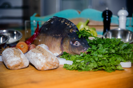 fresh vegetables and fish lying on a wooden table.の写真素材