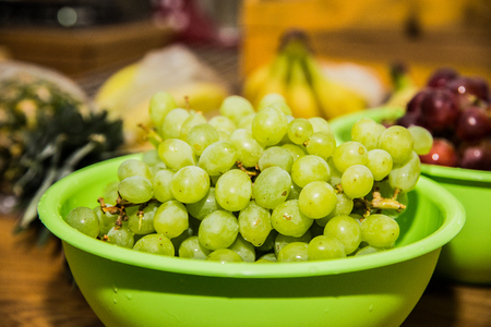 Green grapes on a wooden table.の写真素材