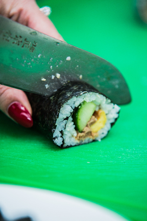 Close up of chef slicing a fresh sushi wrapの写真素材