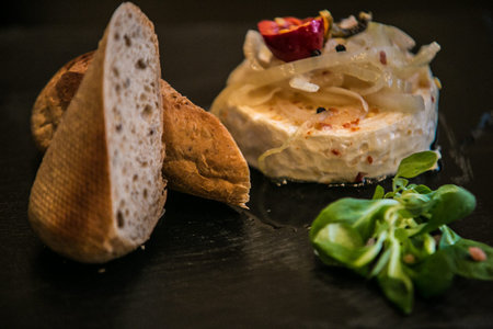 Delicatessen cheese on stone plate. Food background.