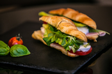Sandwich with delicatessen cheese and fresh leaves salad.の写真素材