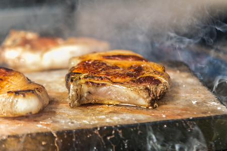 Fresh, delicious grilled meat. Grilling steak on BBQ. Close up view of grilling steakの写真素材