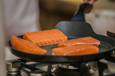 The chef prepares delicious roasted salmonの写真素材