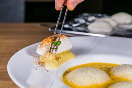 Close up hands of chef preparing food in the kitchen of a restaurant, cooking conceptの写真素材