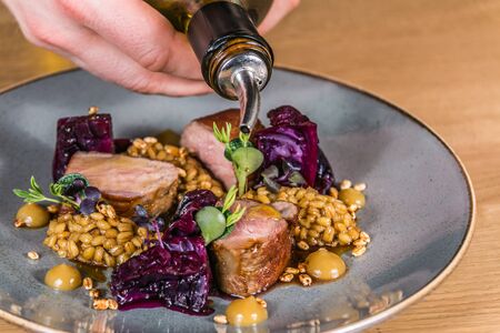 Close up hands of chef preparing food in the kitchen of a restaurant, cooking conceptの写真素材