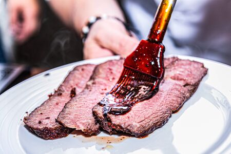 Close up hands of chef preparing food in the kitchen of a restaurant, cooking conceptの写真素材