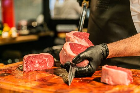 Close up hands of chef preparing food in the kitchen of a restaurant, cooking conceptの写真素材