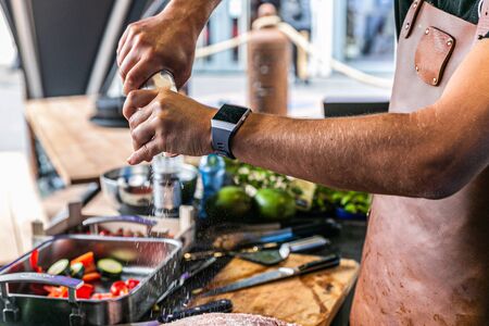 Close up hands of chef preparing food in the kitchen of a restaurant, cooking conceptの写真素材