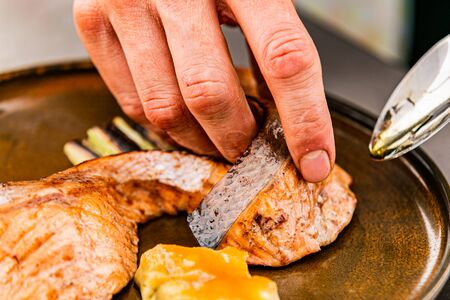 Close up hands of chef preparing food in the kitchen of a restaurant, cooking conceptの写真素材