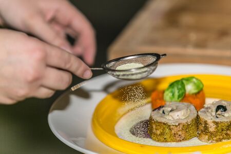 Close up hands of chef preparing food in the kitchen of a restaurant, cooking conceptの写真素材