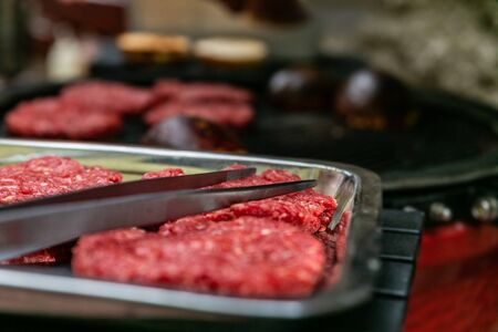 Fresh raw meat cutlets for burger. Closeup. Fast food. Delicious hamburgeの写真素材